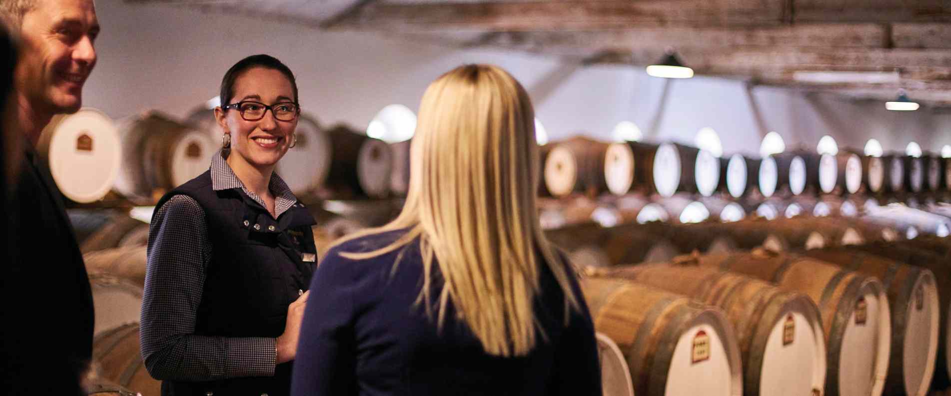 People on a tour of a winery cellar