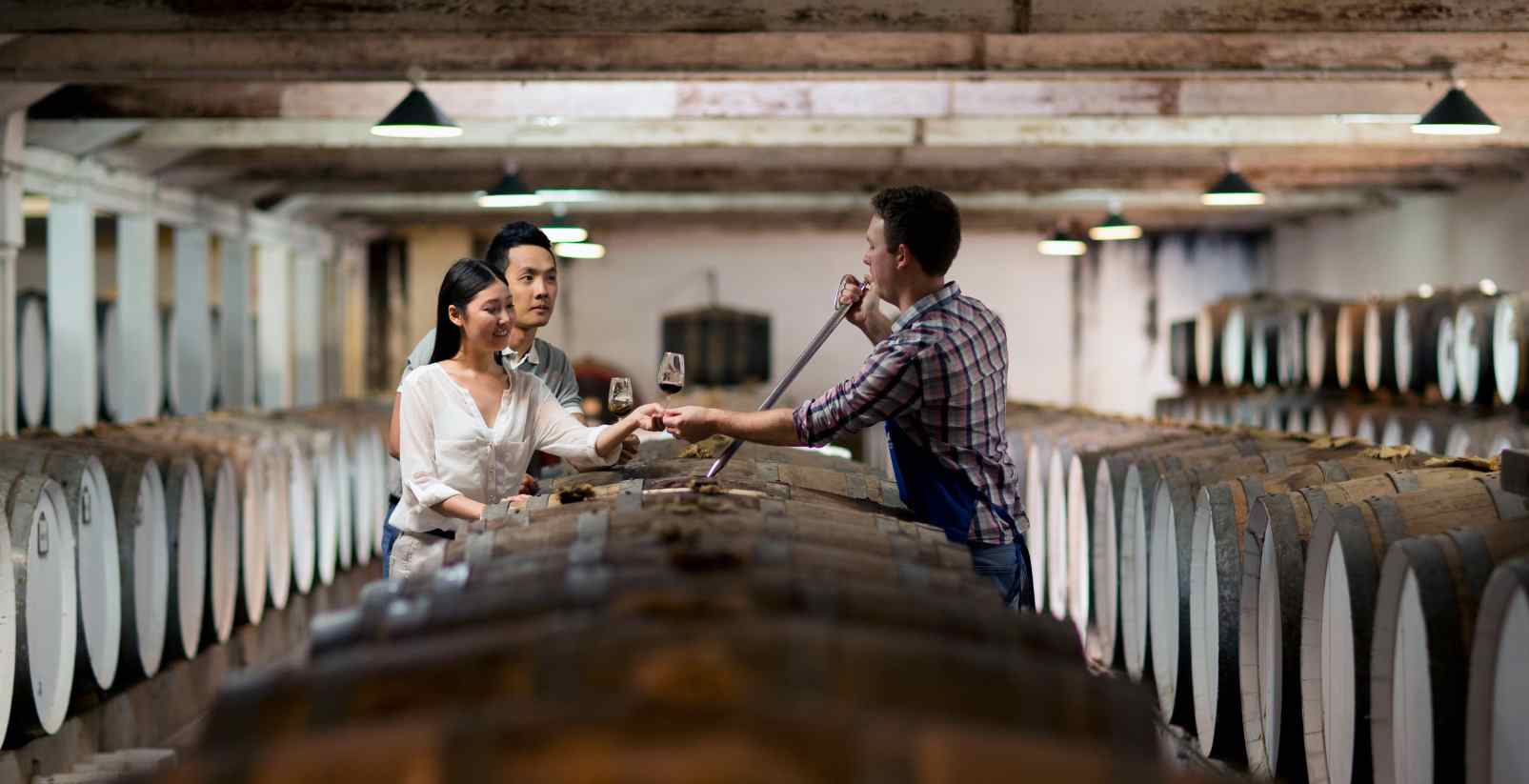 man showing couple wine barrels