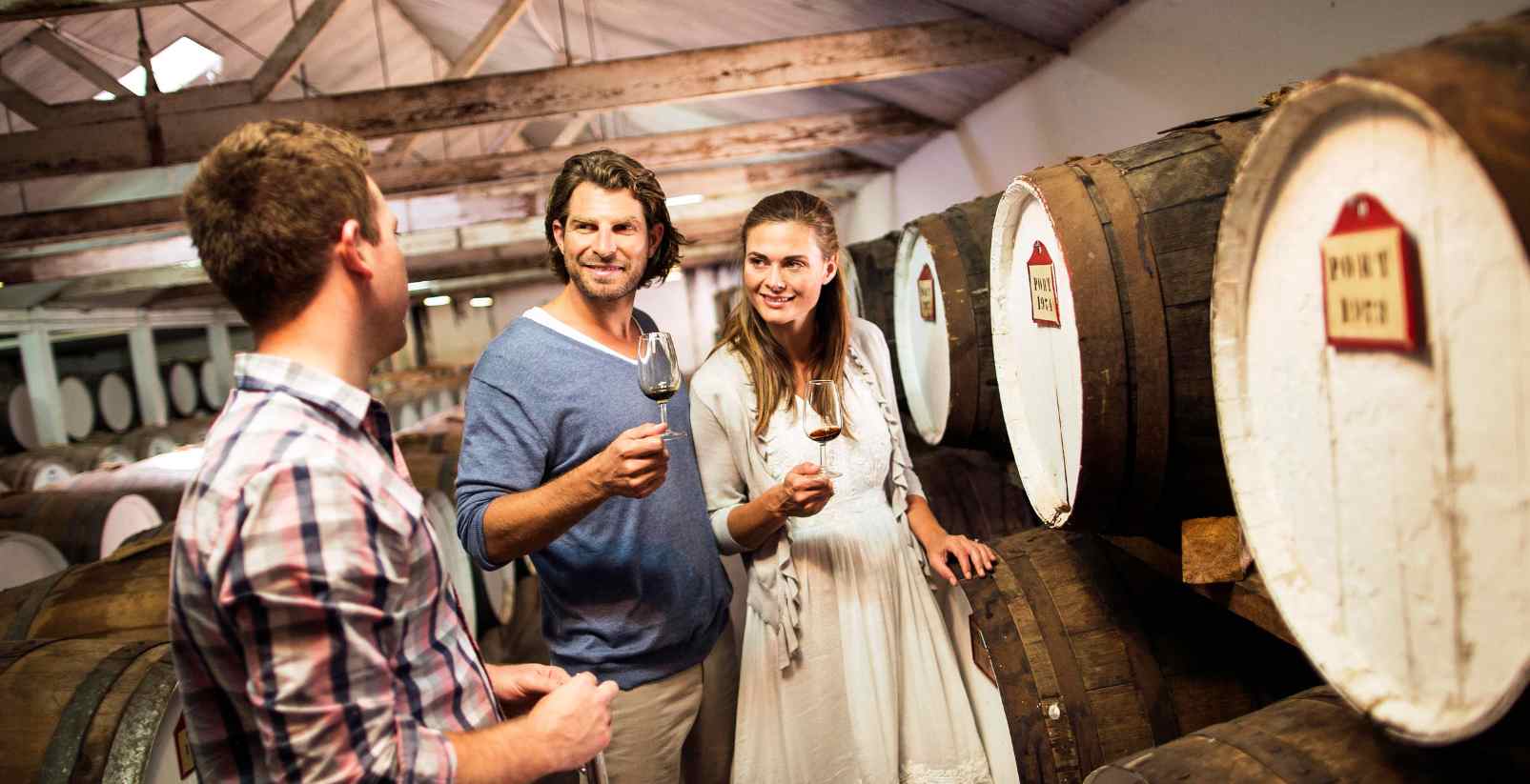 A couple on a wine tour holding wine